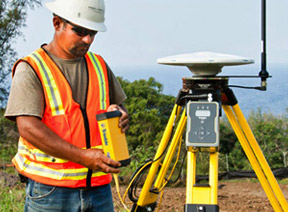 Construction Worker on Site Using Trimble Technology for Site Positioning